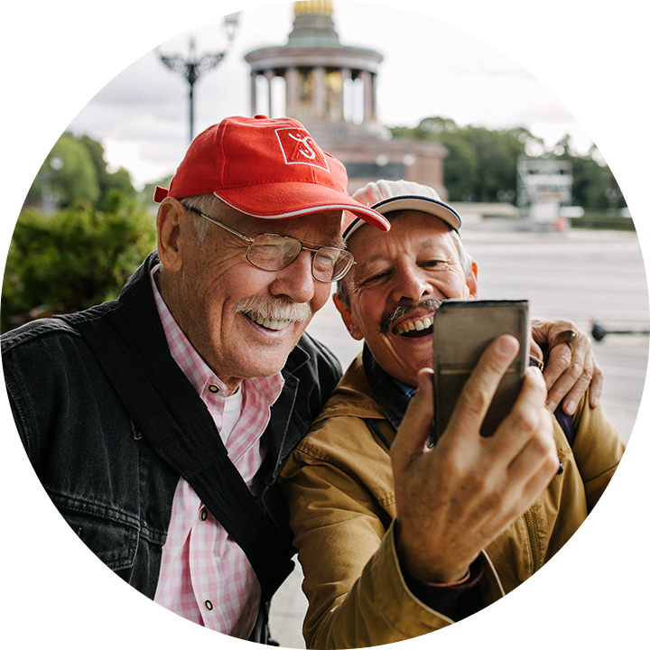 Two older men taking a photo